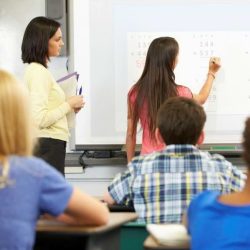 Aws Female Student And Teacher At White Board In Front Of Class