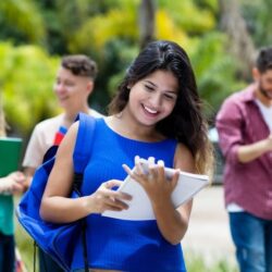 Female Mexican Student Smiling While Holding Notebook