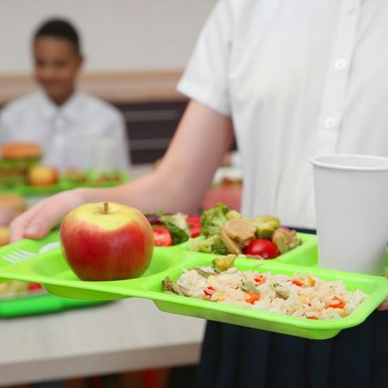 Female Student Holding Lunch Tray With Apple C Vegetables C Rice C And Beverage
