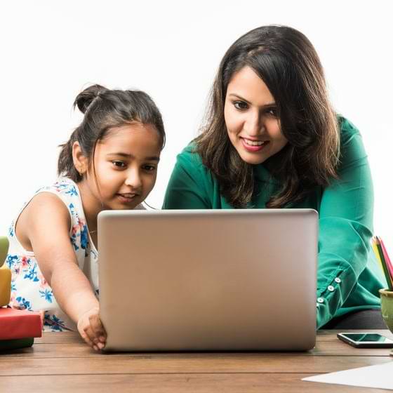 Mother Of Asian Decent With Child At A Computer