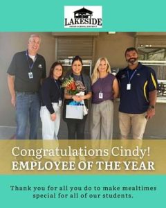 Group of people that says Congratulations Cindy! Employee of the year.